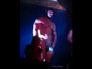 A muscled go-go dancer sporting some huge bulge on stage!