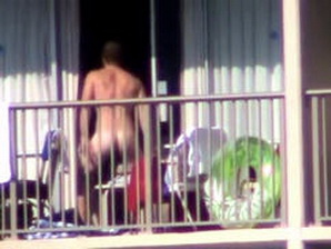 A spycam caught a hot naked guy shaking his bootie on the balcony!