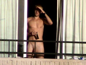 The same hottie is caught naked again on his balcony, and with a semi-boner!