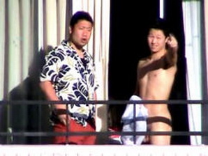 The same dude is caught butt naked on the balcony with a mate!