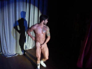 Another muscled tatooed stripper takes it all off on stage!